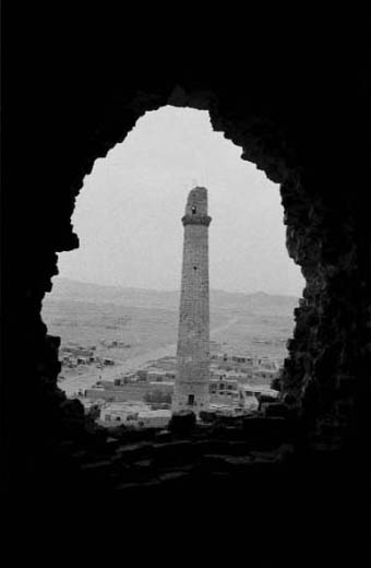 one of the famous minarets of herat, seen through a hole in the wall of another minaret. the hole was caused by the impact of a missile. only five of the formerly 11 minarets are still standing today
